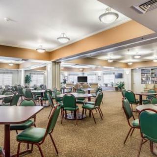 A spacious dining area with multiple tables and chairs set up for guests.