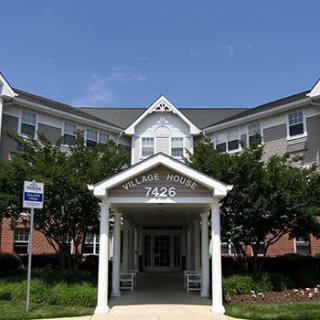 A residential building with a prominent entrance and landscaping.