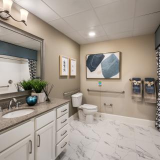 A modern bathroom with sleek decor and neutral tones.