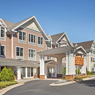A modern residential building with a welcoming entrance on a sunny day.