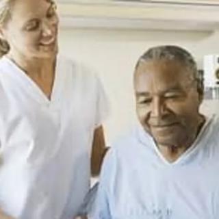 A nurse assists an elderly patient in a healthcare facility.