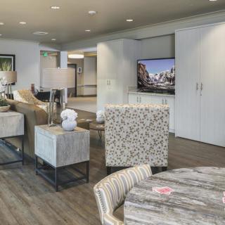 A modern living room with stylish furniture, a flat-screen television, and contemporary decor.