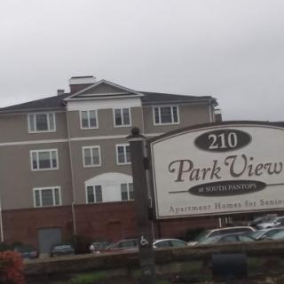 Park View Apartments, a residential building with signage in an urban setting.