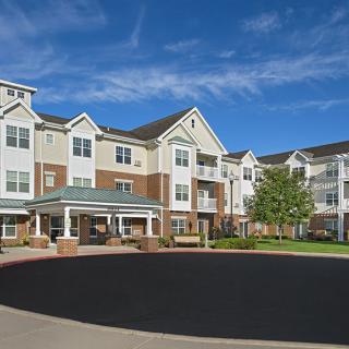A modern residential apartment complex with a landscaped courtyard.