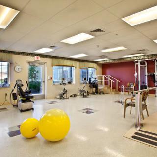 A spacious gym with various exercise equipment and fitness tools.