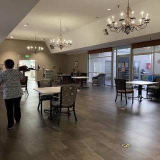 A spacious dining area featuring elegant chandeliers and a cozy atmosphere.