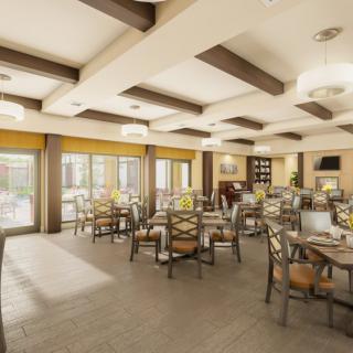 A well-lit dining room with neatly arranged tables and chairs, featuring wooden beams and large windows.
