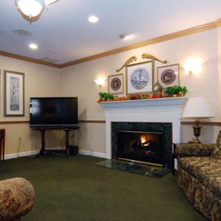 A cozy living room with a fireplace, TV, and comfortable seating.