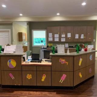 An office reception desk decorated with colorful ice cream stickers.