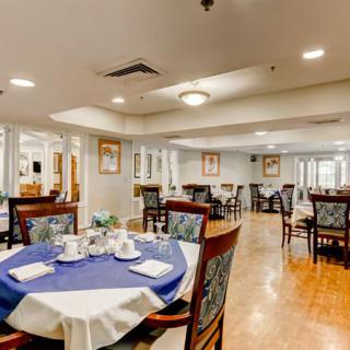 Spacious dining area with elegantly set tables and comfortable seating.