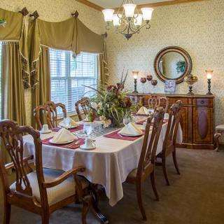 A beautifully set dining room table with elegant furnishings and dcor.