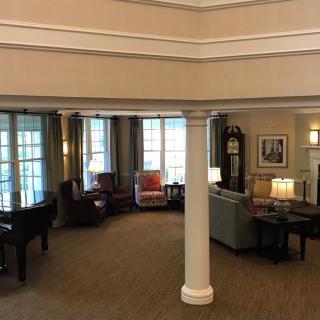 A cozy lobby interior with seating areas, large windows, and elegant lighting.