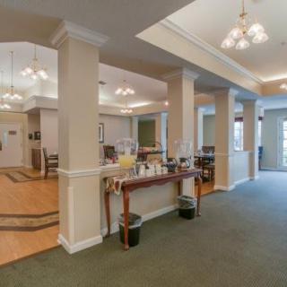 A well-lit reception area featuring elegant furniture and decor.