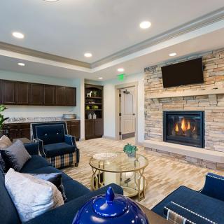 A modern living room with a cozy fireplace and elegant seating area.