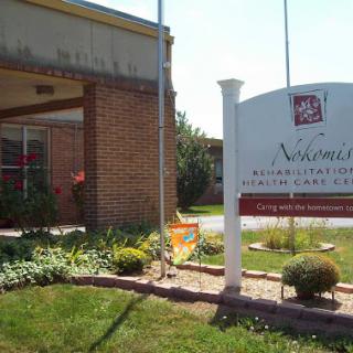 Entrance of a healthcare facility with well-maintained landscaping.