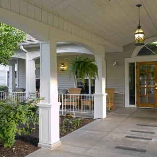 A welcoming front entrance with columns and greenery.