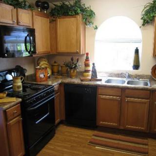 A cozy kitchen with wooden cabinets and modern appliances.
