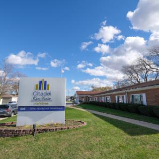 A clear day showcasing a building with prominent signage in a well-maintained outdoor setting.
