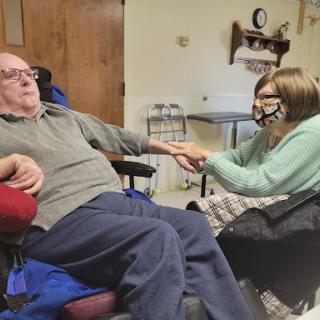 A heartwarming moment between a caregiver and an elderly individual, showcasing care and connection.