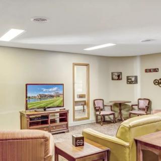 A cozy living room with comfortable seating, a television, and tasteful decor.