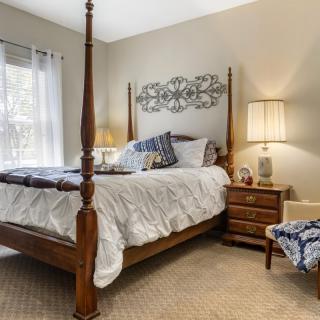 A cozy bedroom with a four-poster bed and elegant decor.