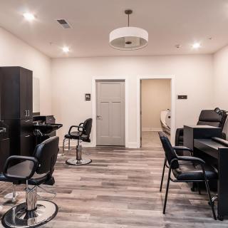 Modern beauty salon with multiple workstations and stylish decor.