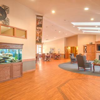 A modern lobby area featuring an aquarium, comfortable seating, and bright lighting.