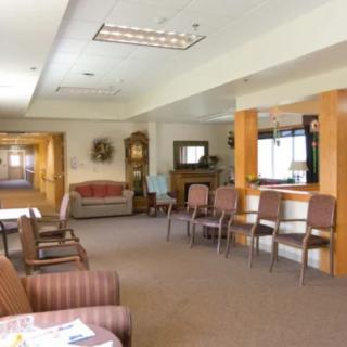 A cozy waiting room with multiple chairs and a reception area.