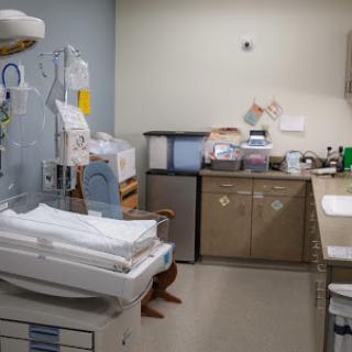 A view of a hospital room equipped for patient care, featuring various medical tools and supplies.