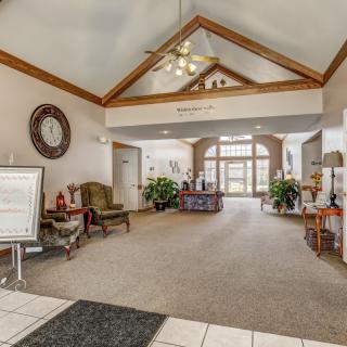 A spacious lobby with seating areas, decorative elements, and a welcoming reception desk.