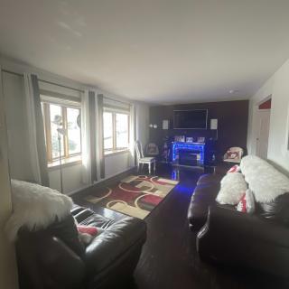 A cozy living room with modern furnishings and ambient lighting.