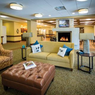 A cozy living room with a fireplace and comfortable seating.
