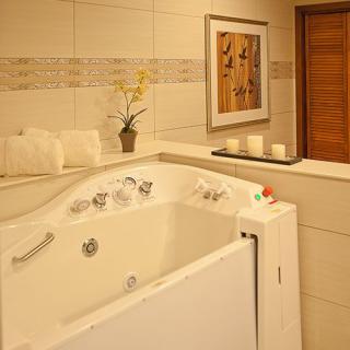 A luxurious bathroom with a spa-style bathtub and elegant decor.