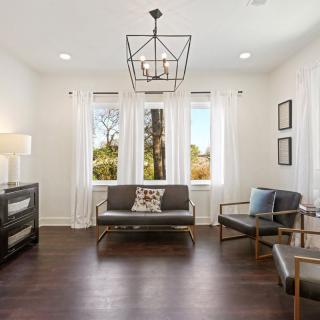 A modern and minimalist living room with ample natural light and stylish furniture.