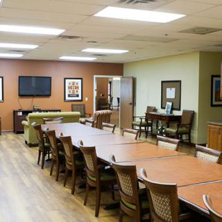 A modern conference room with a long table and multiple chairs, suitable for meetings or collaborative work.