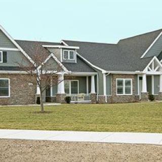 A modern suburban house with a well-maintained lawn.
