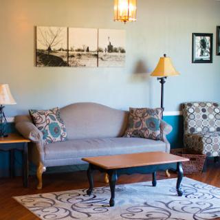 A cozy living room with stylish furniture and decorative elements.