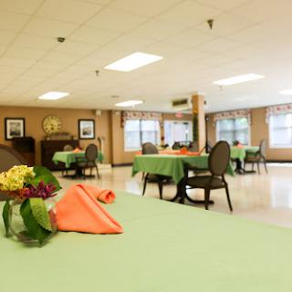 A spacious and inviting dining area with neatly arranged tables, adorned with colorful table settings.