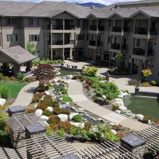 A beautifully landscaped apartment courtyard featuring gardens and water features.