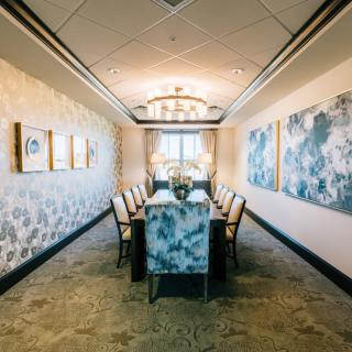 A luxurious dining room with elegant decor and a chandelier.
