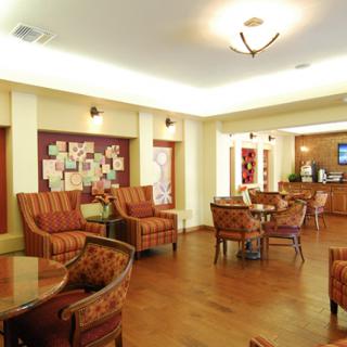 A cozy lounge area with comfortable seating and warm lighting.