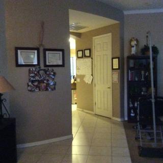 A cozy home hallway with framed pictures and a bookshelf.