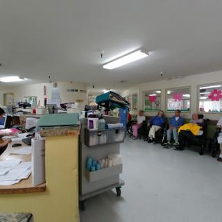 A busy waiting room in a healthcare facility where patients are seated, highlighting the clinical environment.