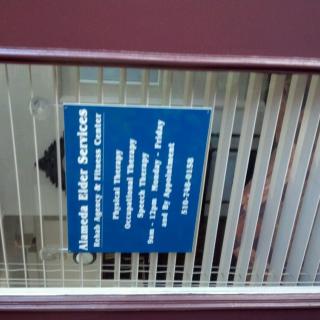 A sign displaying the office information and business hours for a water services provider.