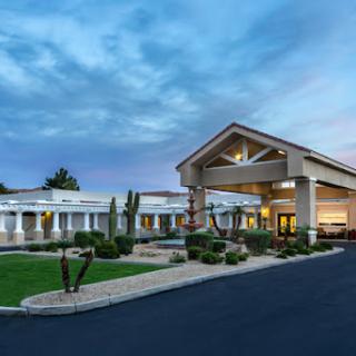 A welcoming hotel entrance under a serene evening sky.