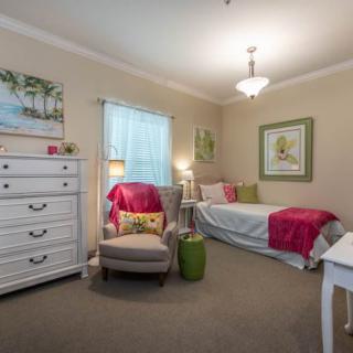 A cozy bedroom with colorful decor and comfortable furnishings.