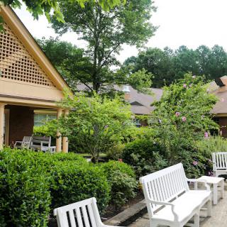 A serene outdoor space featuring well-maintained gardens and comfortable seating.