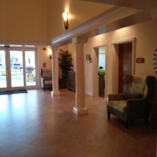 A spacious lobby area featuring elegant lighting and comfortable seating.