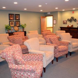 A cozy waiting room with several comfortable chairs arranged in rows.
