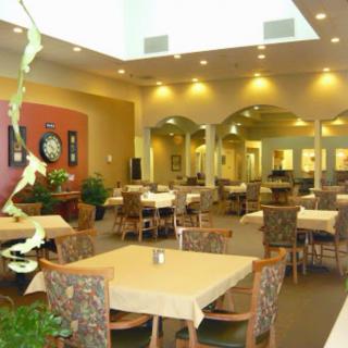 A spacious and elegantly decorated dining area with tables and chairs arranged neatly.